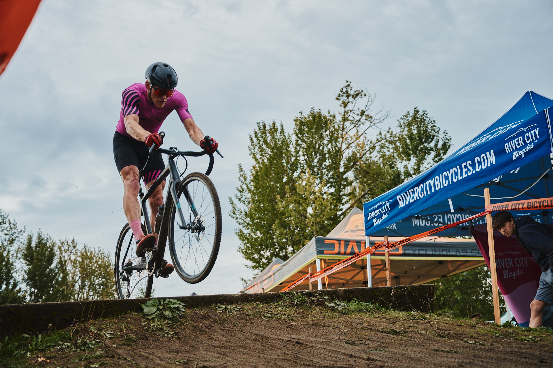 A Cyclocross Racer jumps over a large concrete slab at Cross Crusade Heron Lakes 2023