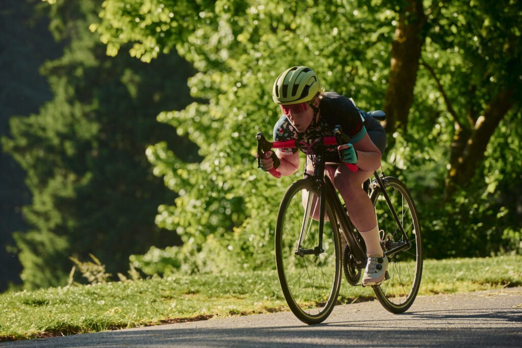 A Bike racer tucks on her bike into an aerodynamic position at the descent on Mt Tabor